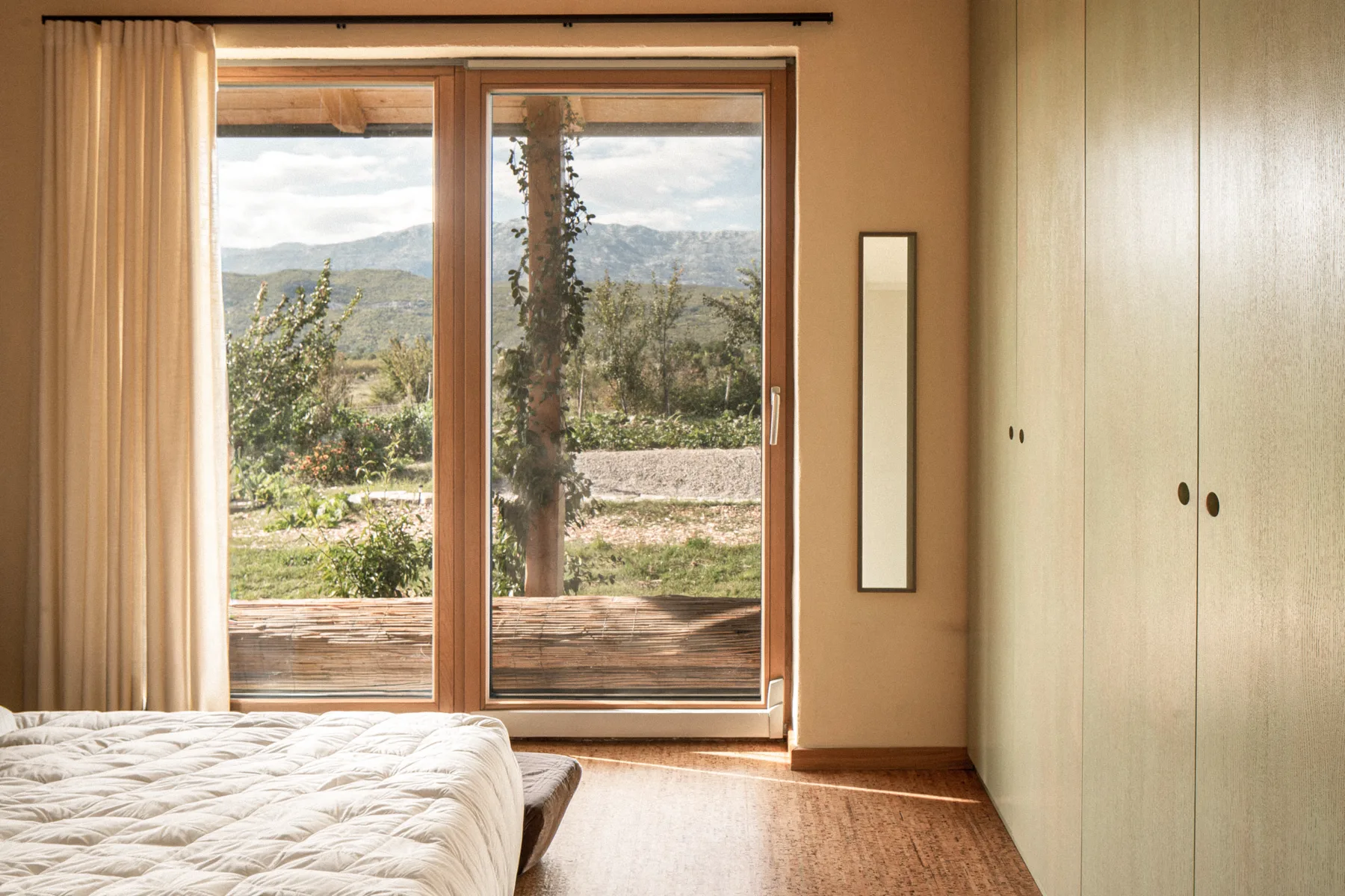 The master bedroom, sliding doors opening to the karst landscape